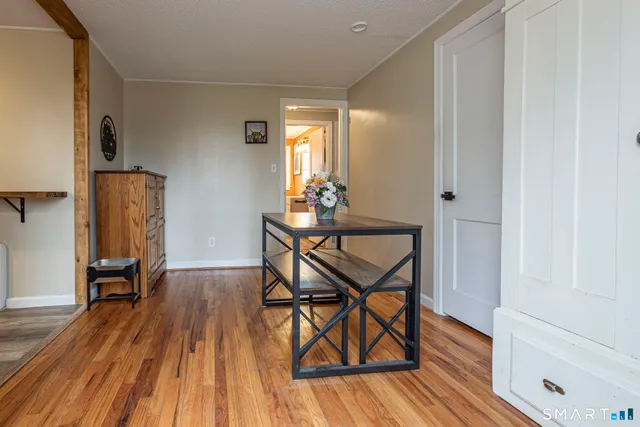 a dining room with furniture and wooden floor