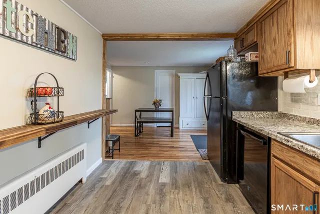 a view of living room with furniture and wooden floor
