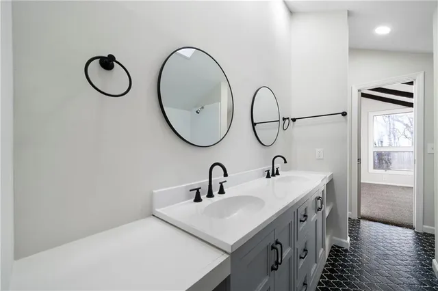 a bathroom with a sink and a mirror