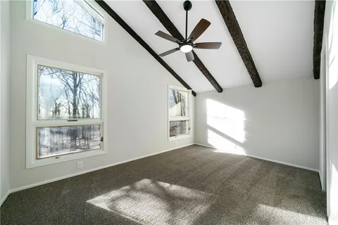 a view of an empty room with windows