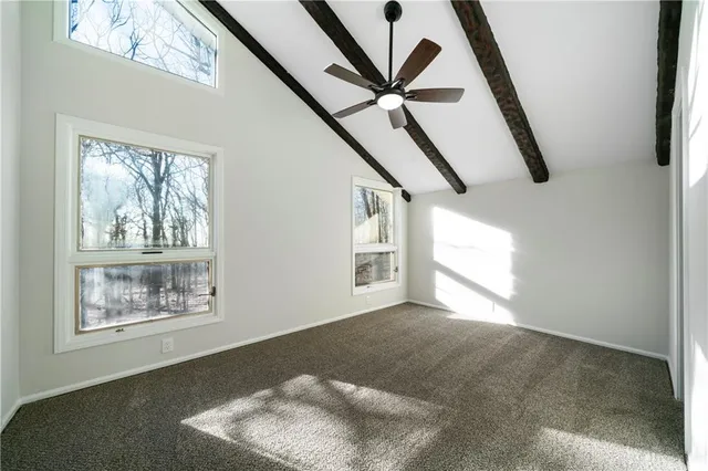 a view of an empty room with windows