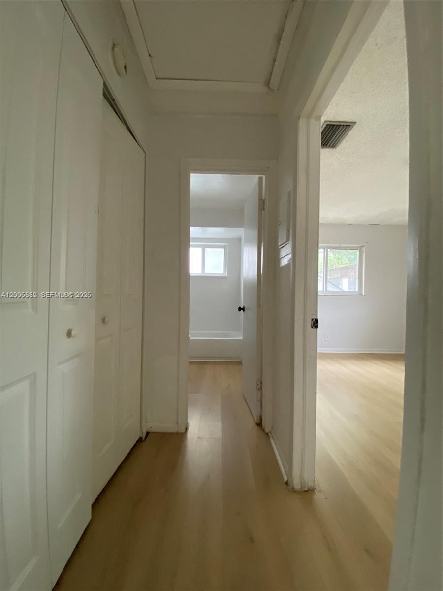 6132 Southwest 39th Street, Unit R Miramar, FL 33023 - Photo 11 of 21 a view of a hallway with wooden floor