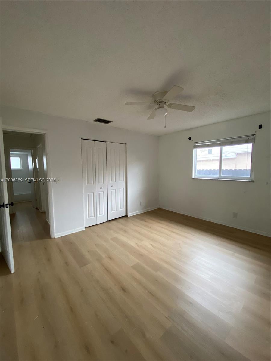 6132 Southwest 39th Street, Unit R Miramar, FL 33023 - Photo 17 of 21 a view of an empty room with wooden floor and a window