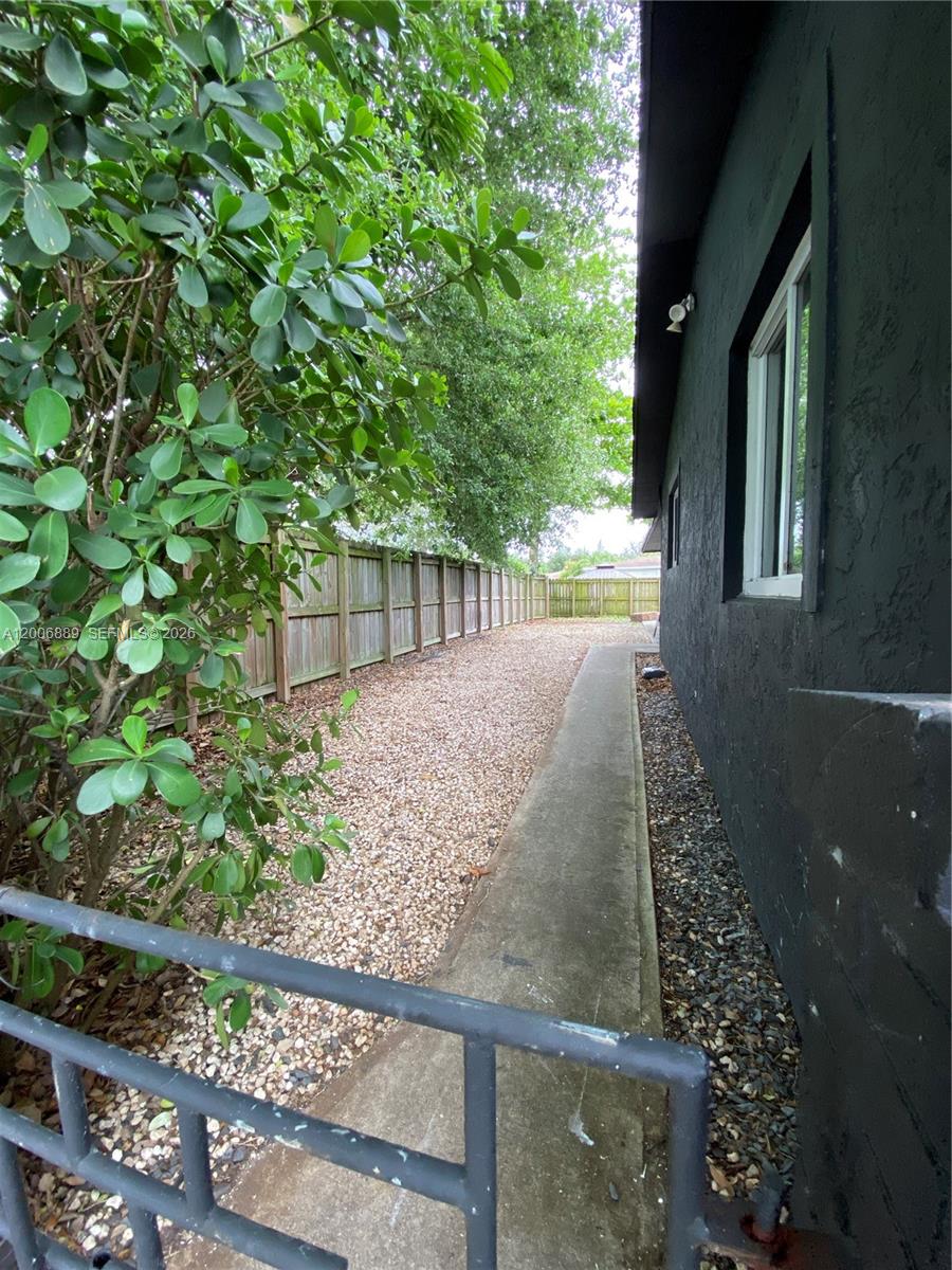 6132 Southwest 39th Street, Unit R Miramar, FL 33023 - Photo 3 of 21 a view of backyard with plants and outdoor seating