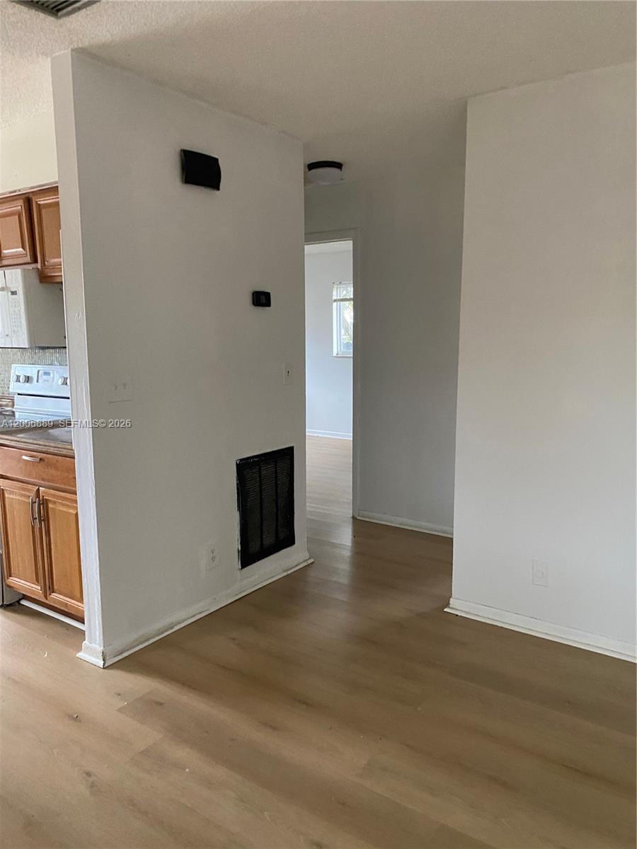 6132 Southwest 39th Street, Unit R Miramar, FL 33023 - Photo 10 of 21 an empty room with wooden floor