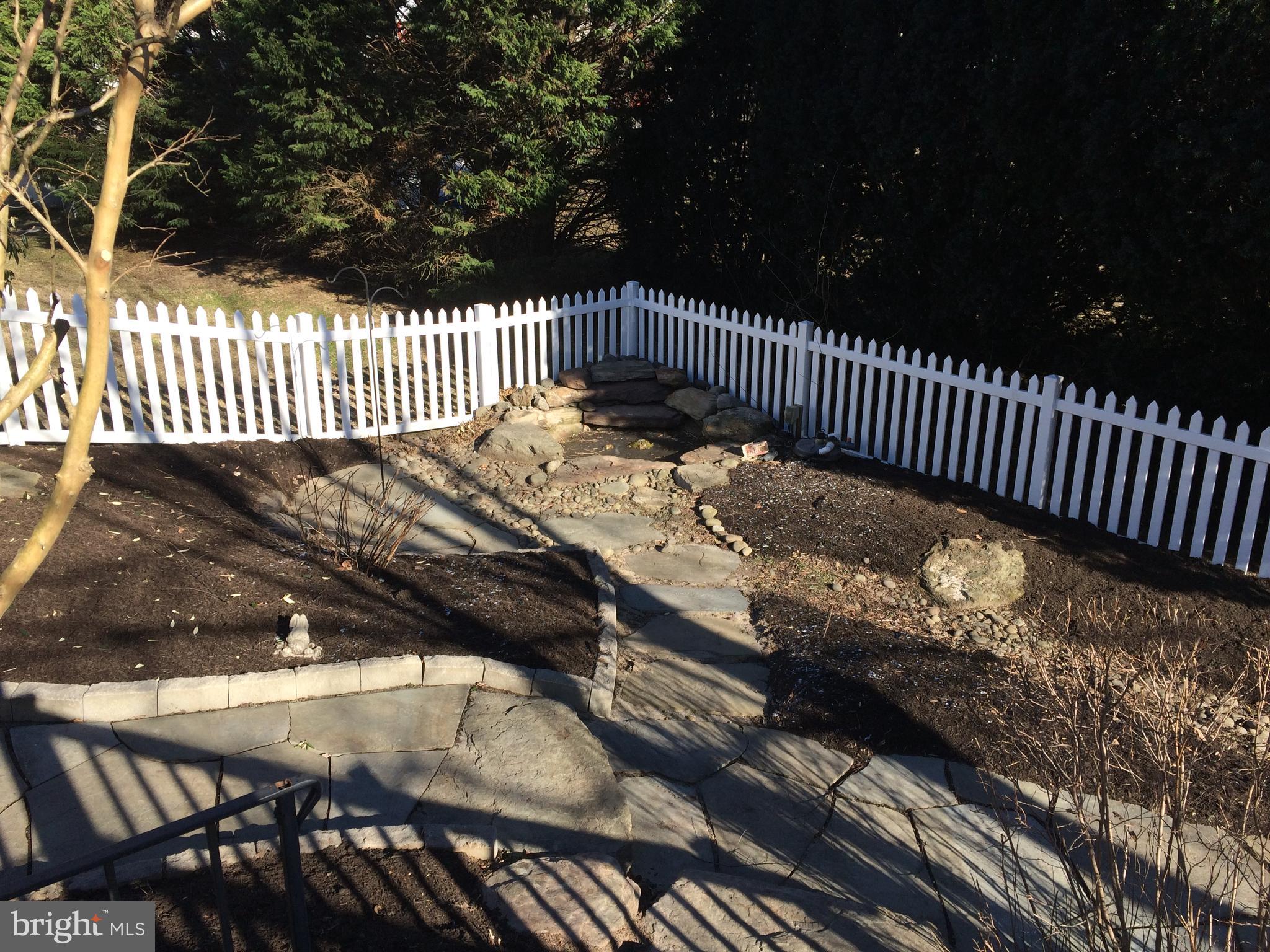 7805 Notley Road Pasadena, MD 21122 - Photo 23 of 30 Back yard with walkways & pond w/ waterfall
