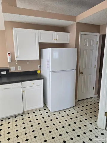 a kitchen with a refrigerator and a sink