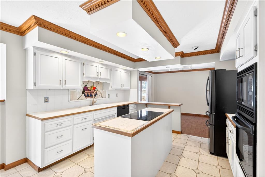 16 Ridgewood Drive McDonald, PA 15057 - Photo 12 of 47 a kitchen with white cabinets a sink dishwasher and a stove with wooden floor