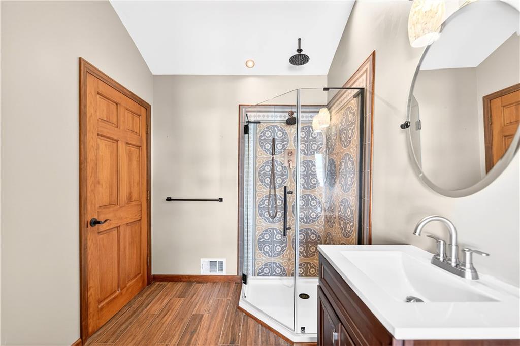 16 Ridgewood Drive McDonald, PA 15057 - Photo 21 of 47 a bathroom with a sink a mirror a vanity and shower