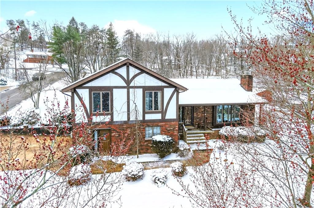 16 Ridgewood Drive McDonald, PA 15057 - Photo 47 of 47 a front view of a house with a yard covered with snow in the background