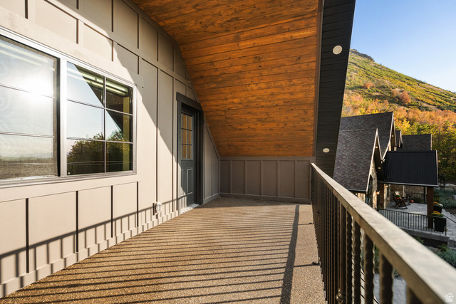 1141 South Oak Leaf Lane Springville, UT 84663 - Photo 93 of 147 ADU Exterior balcony featuring a textured surface, dark metal railing, and a natural wood-finish ceiling