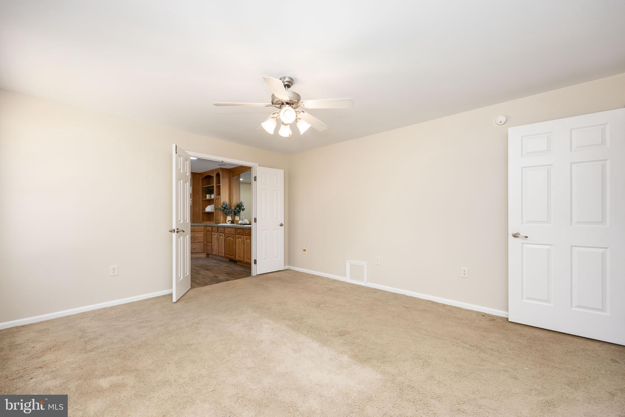 6635 Libertytown Road Berlin, MD 21811 - Photo 28 of 88 a view of a kitchen with an empty space and a ceiling fan