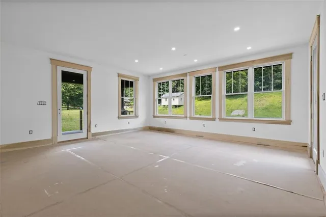 a view of a livingroom with a fireplace and window