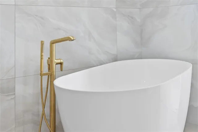 a bathroom with a bathtub and a shower