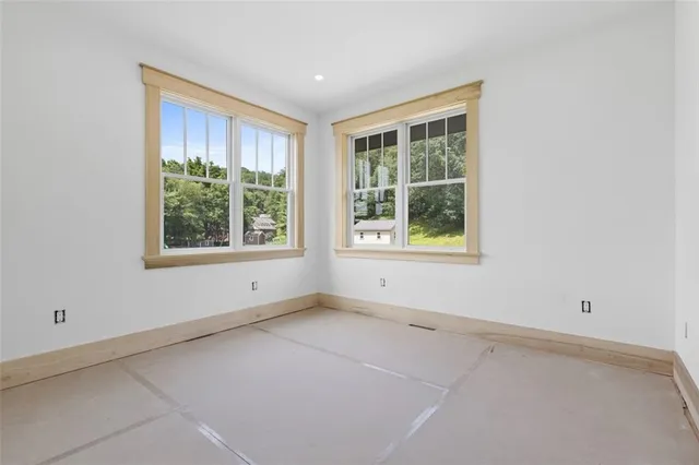 an empty room with closet and windows