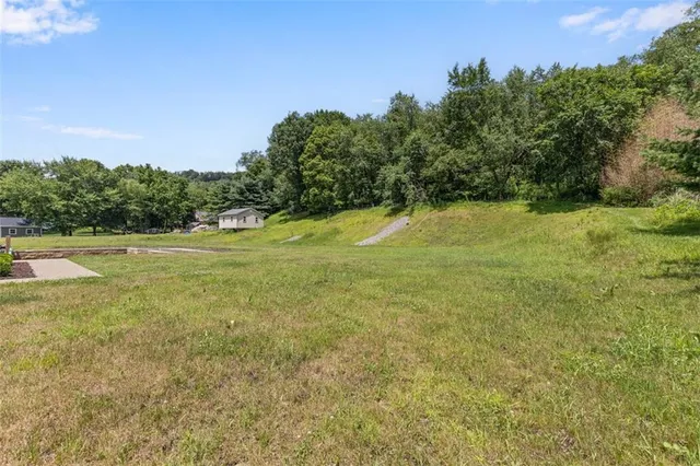 a view of a house with a yard and sitting area