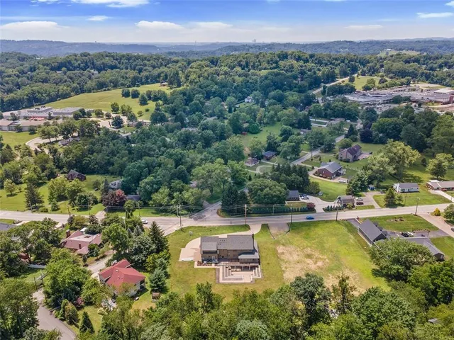 a front view of a house with a yard table and chairs
