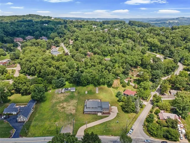 a view of a house with a backyard porch and sitting area