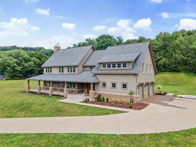 a front view of a house with a garden and deck