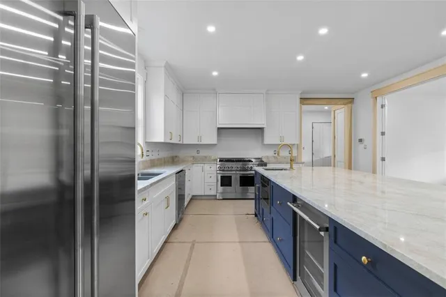a large kitchen with stainless steel appliances lots of counter top space and cabinets