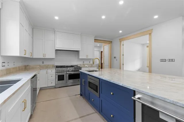 a kitchen with a sink stove and cabinets
