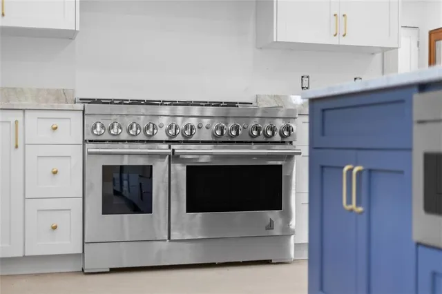 a stove top oven sitting inside of a kitchen