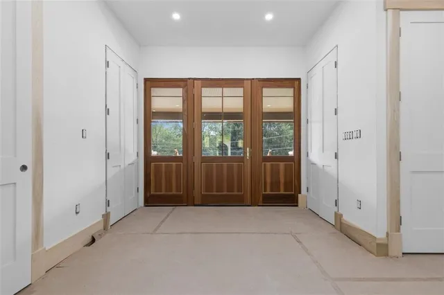 a view of room with walk in closet and wooden cabinet