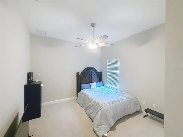 a living room with furniture a clock and a window