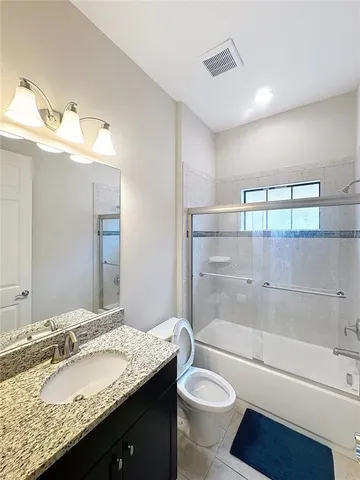 a bedroom with a bed and a ceiling fan