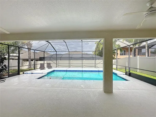 a kitchen with a table chairs refrigerator and cabinets