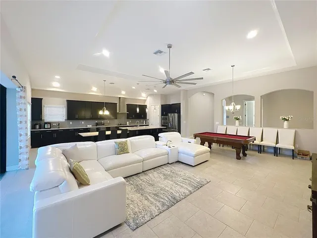 a large white kitchen with a table and chairs