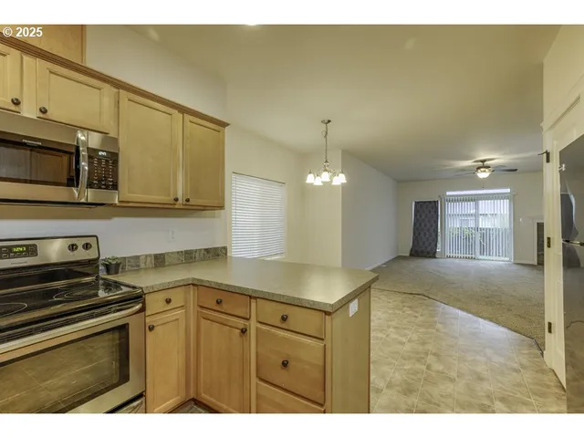 a kitchen with a sink cabinets and stainless steel appliances