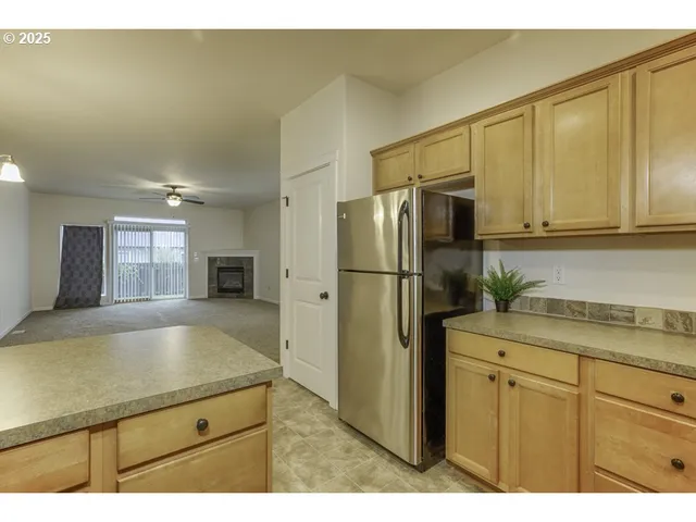 a kitchen with stainless steel appliances granite countertop a refrigerator and a sink