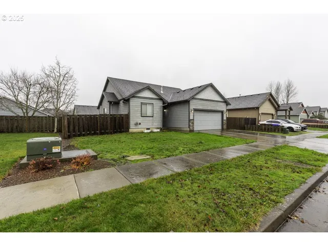 a view of a house with a yard and sitting area