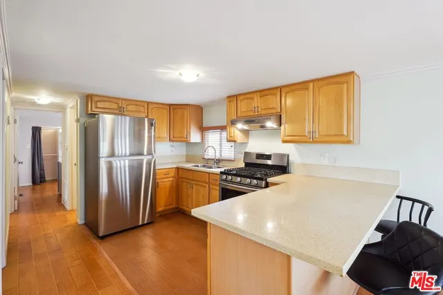 a kitchen with stainless steel appliances a refrigerator and a sink
