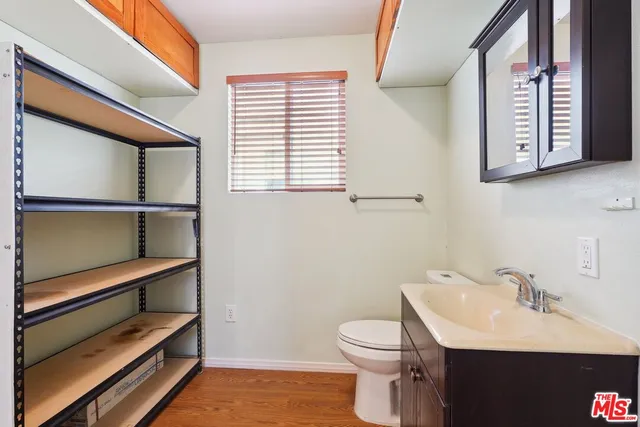 a bathroom with a sink a toilet and vanity