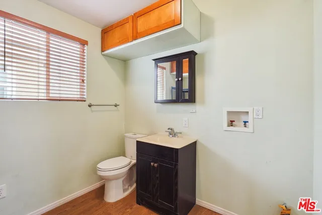 a bathroom with a toilet a sink and a window
