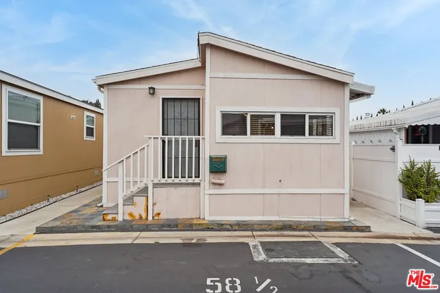 a front view of a house with a view of garage