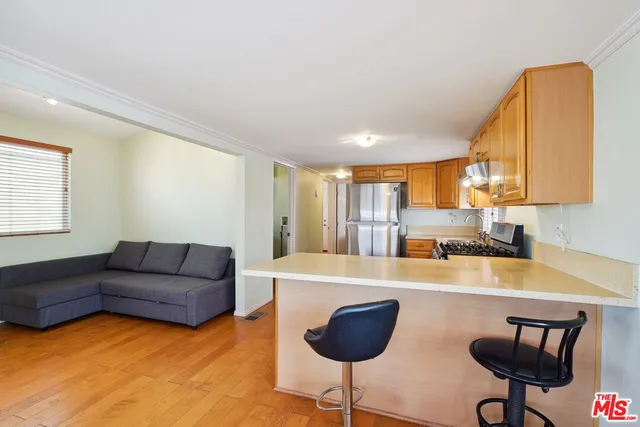 a living room with furniture and a kitchen