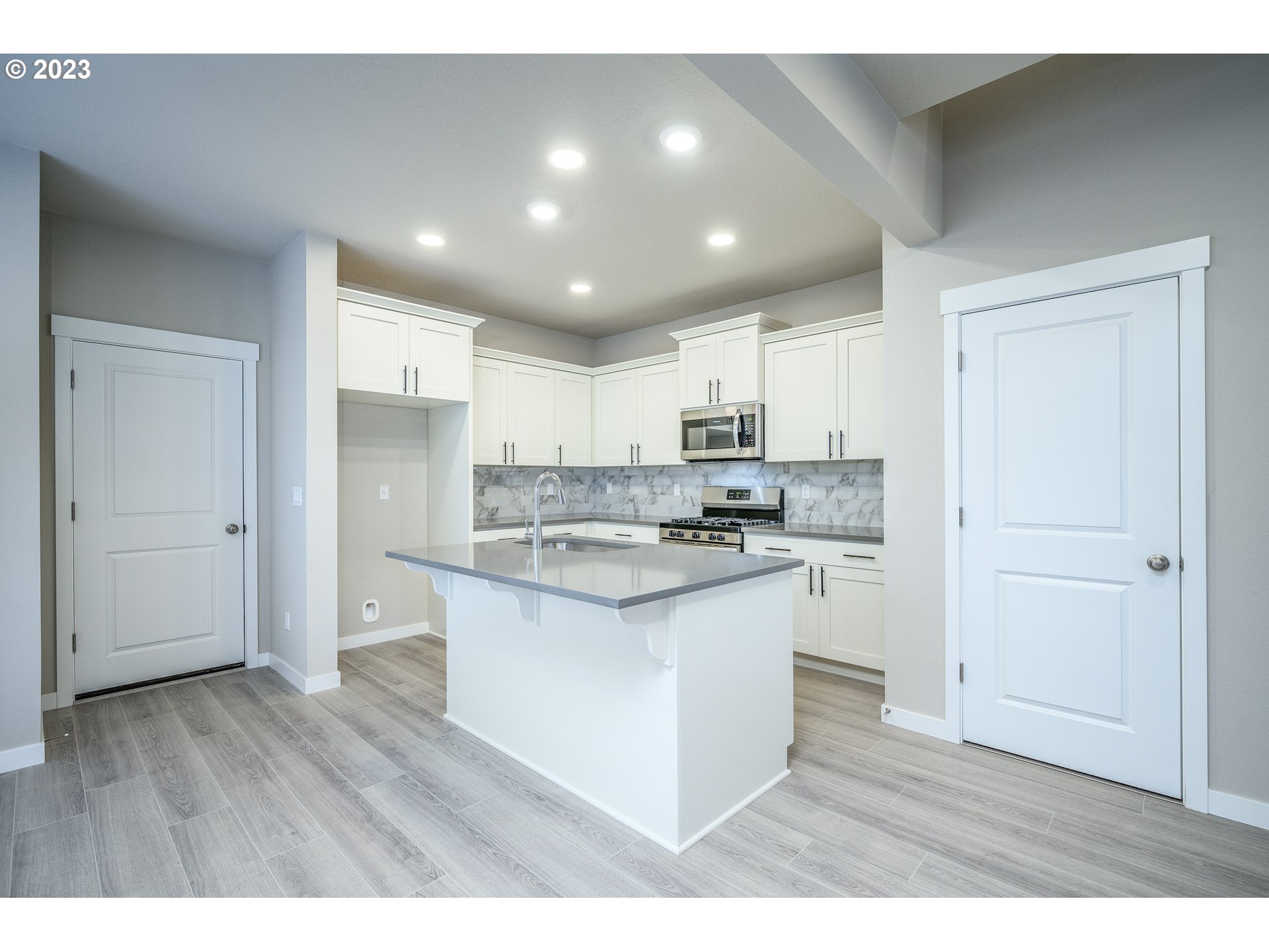 3080 South Kodiak Street, Unit LT813 Cornelius, OR 97113 - Photo 11 of 37 a kitchen with stainless steel appliances granite countertop a stove a sink and a refrigerator with wooden floor
