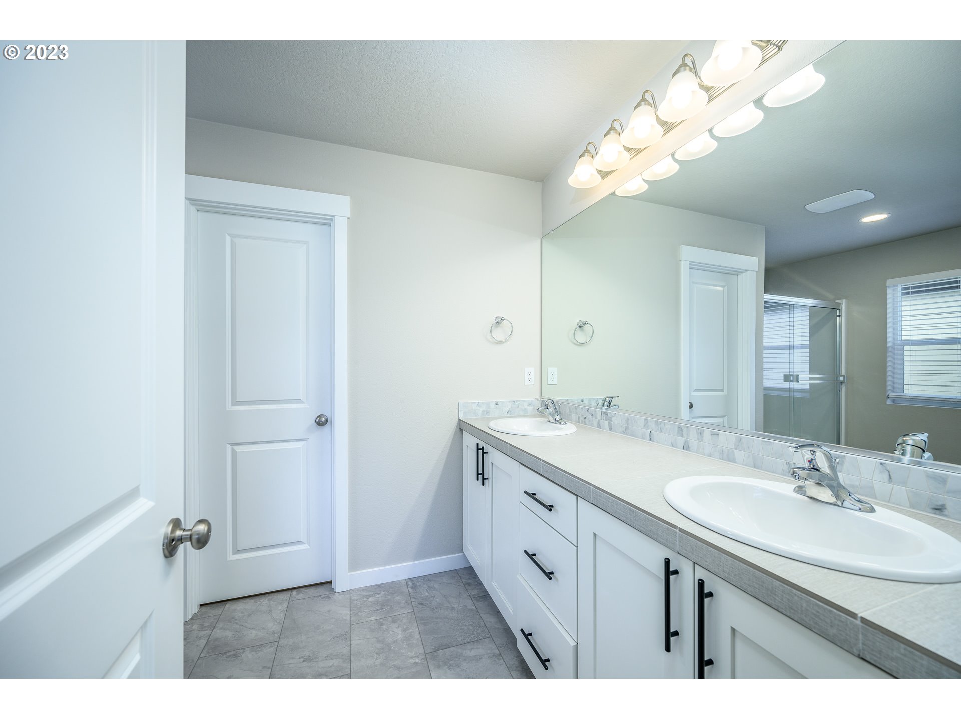 3080 South Kodiak Street, Unit LT813 Cornelius, OR 97113 - Photo 19 of 37 a bathroom with a granite countertop sink a large mirror and a shower