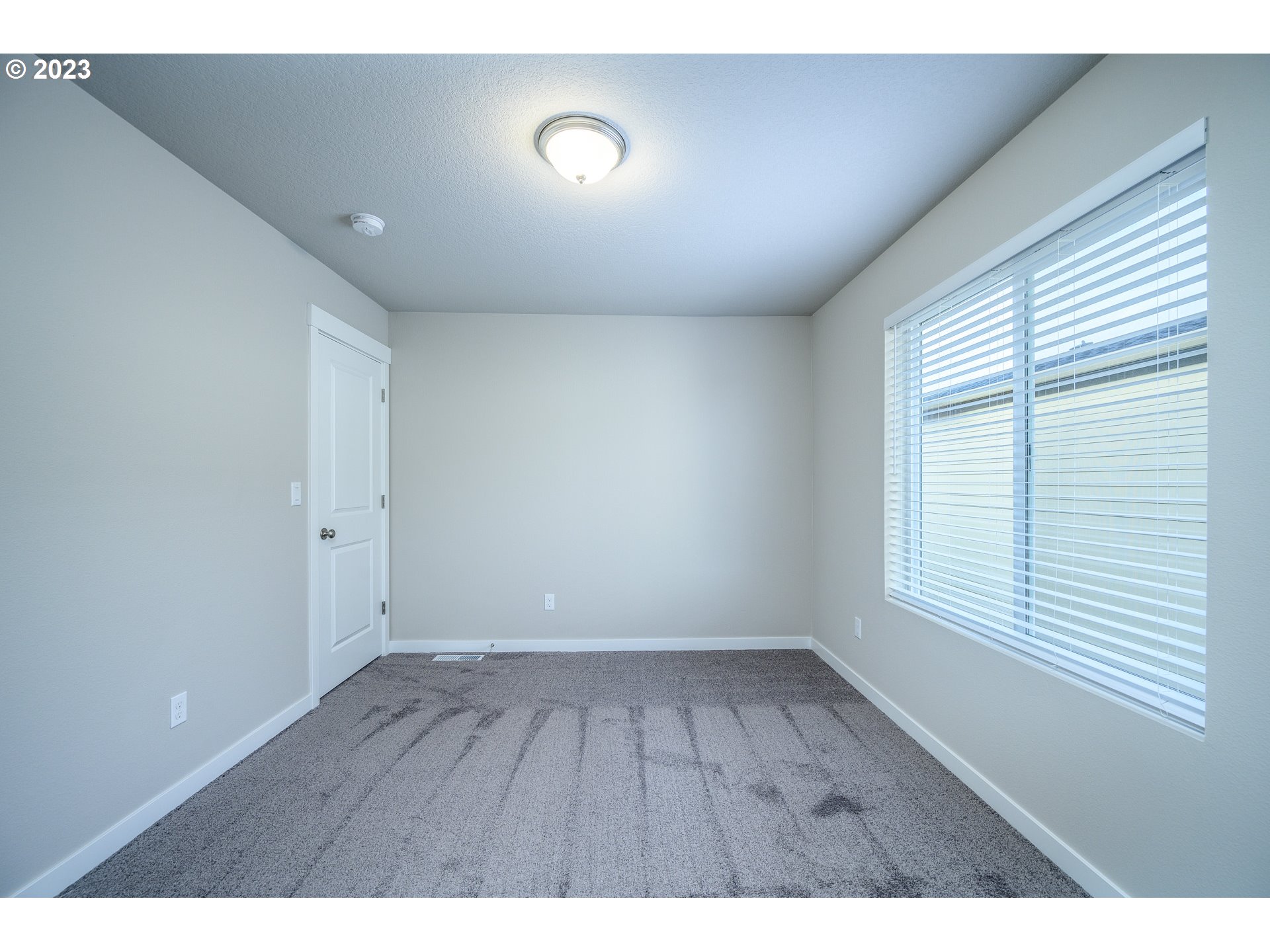 3080 South Kodiak Street, Unit LT813 Cornelius, OR 97113 - Photo 25 of 37 a view of an empty room with wooden floor and a window