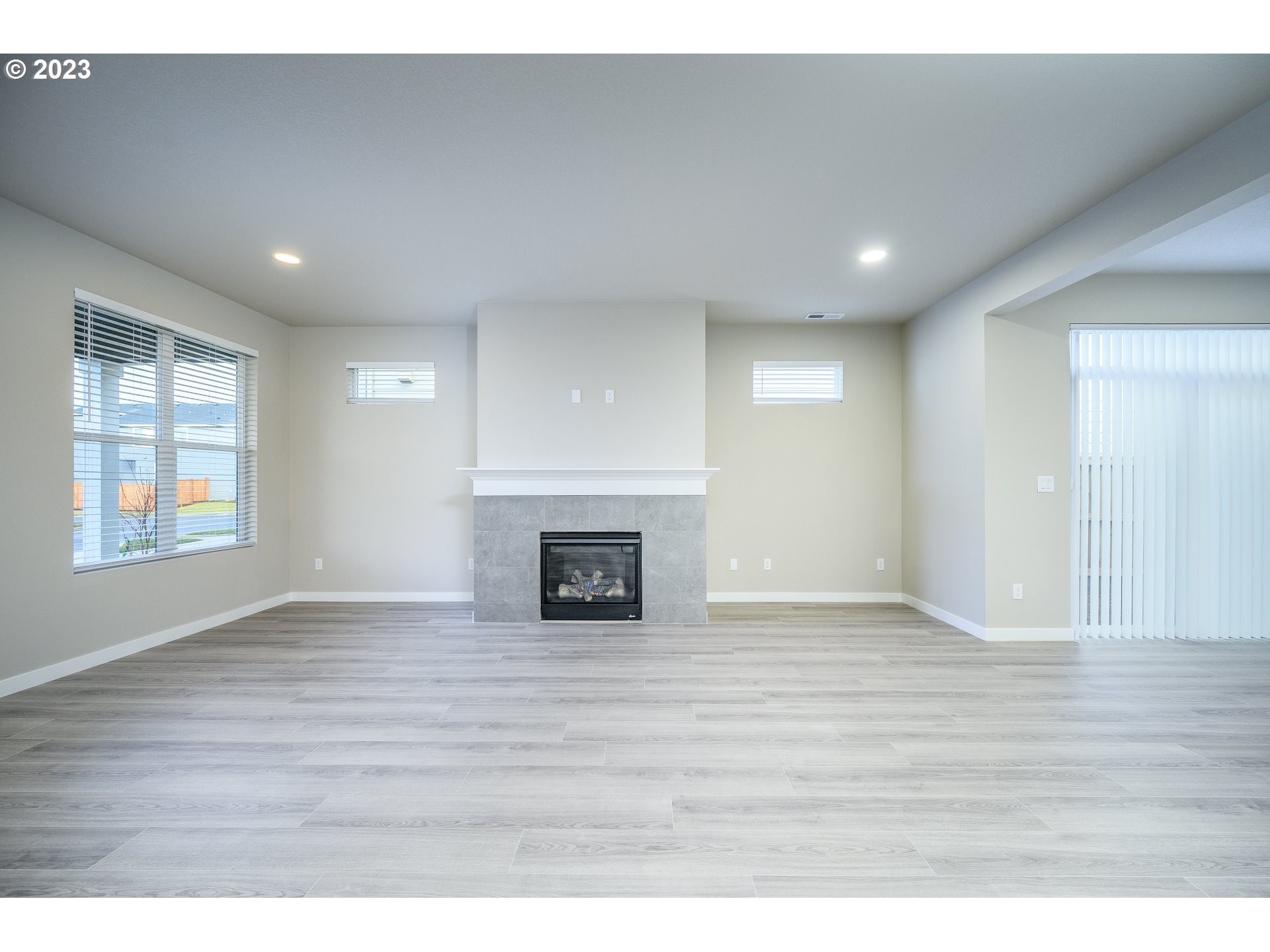 3080 South Kodiak Street, Unit LT813 Cornelius, OR 97113 - Photo 5 of 37 a view of an empty room with window and wooden floor