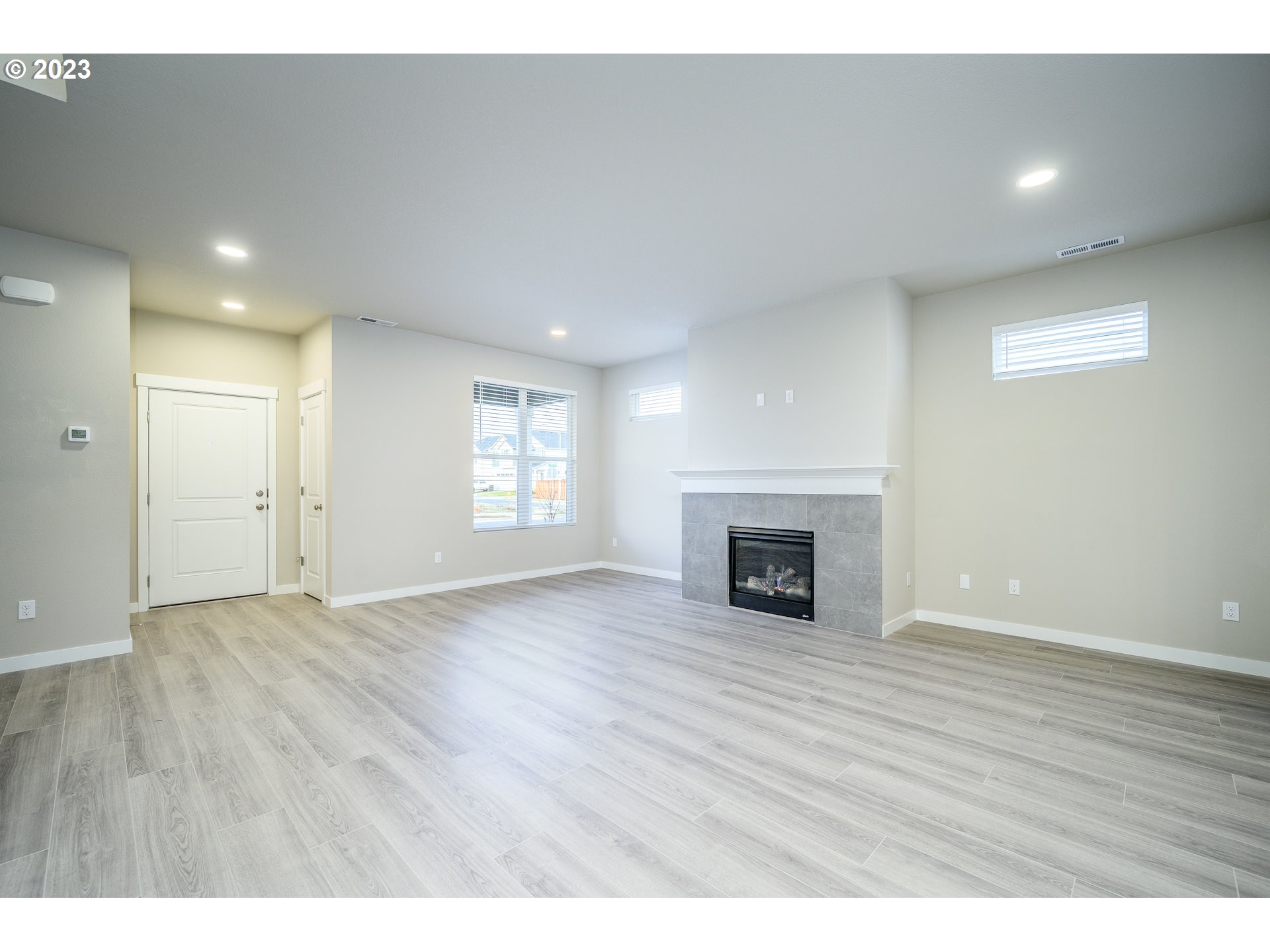 3080 South Kodiak Street, Unit LT813 Cornelius, OR 97113 - Photo 7 of 37 a view of an empty room with wooden floor fireplace and a window