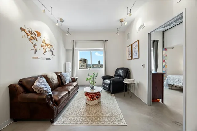 a living room with furniture a rug and a chandelier