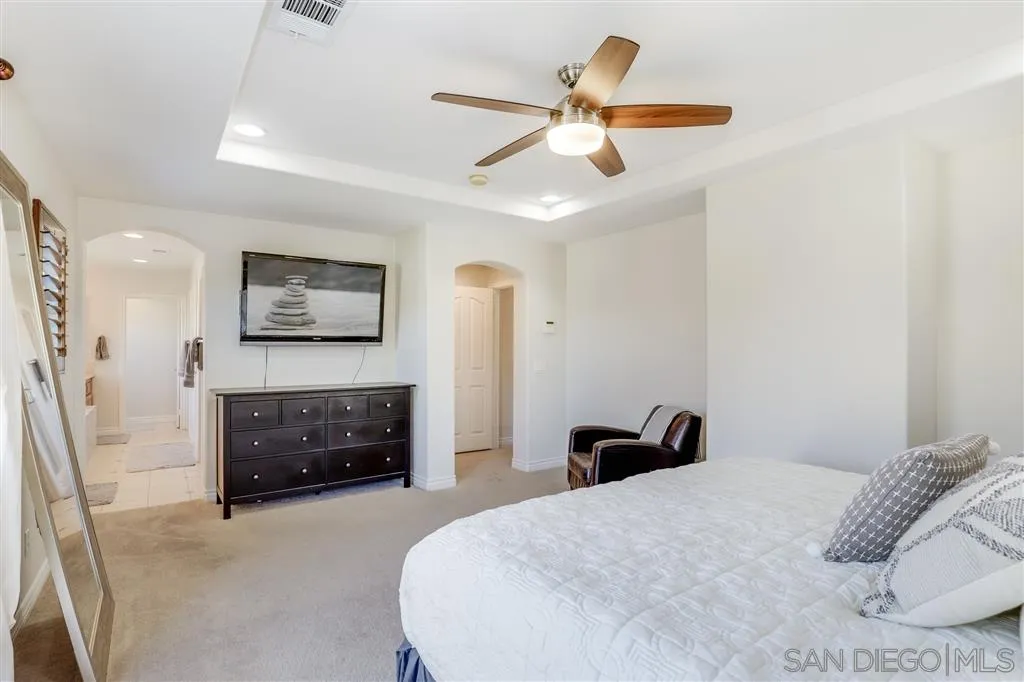 1770 Grain Mill Road San Marcos, CA 92078 - Photo 17 of 25 a bedroom with a bed and a chandelier