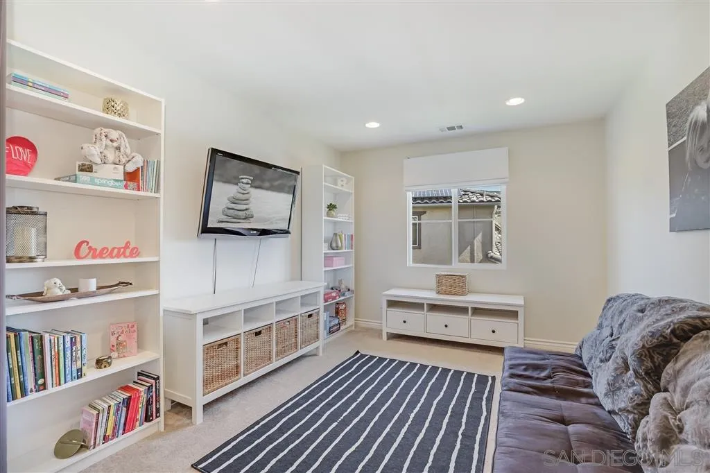1770 Grain Mill Road San Marcos, CA 92078 - Photo 20 of 25 a bedroom with furniture and a book shelf