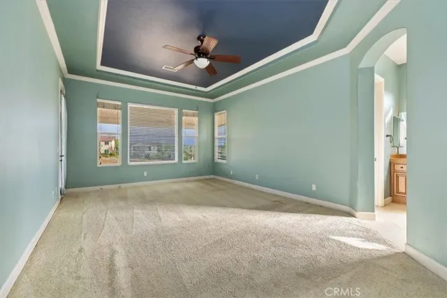a view of a porch with furniture and floor to ceiling window