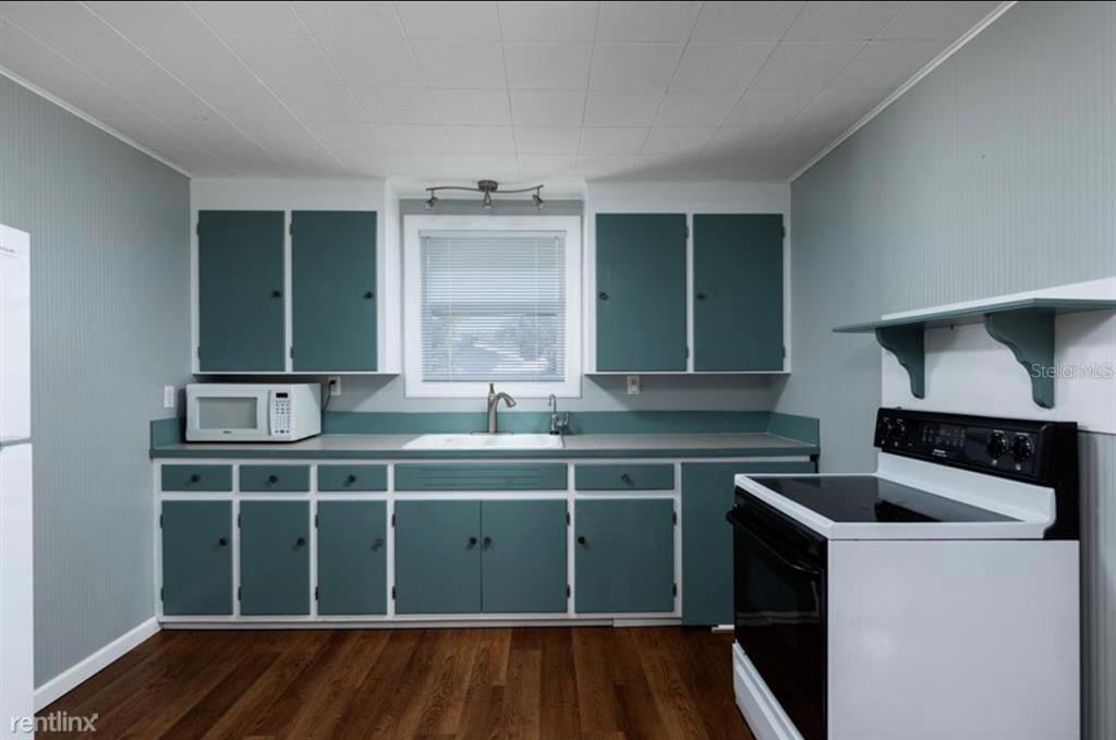 3630 38th Avenue North St. Petersburg, FL 33713 - Photo 4 of 17 a kitchen with a sink cabinets and window