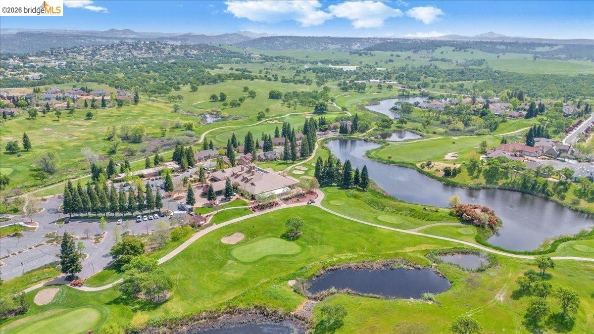 258 Rock Ridge Lane Copperopolis, CA 95228 - Photo 13 of 47 Aerial perspective of suburban area with a golf course and a water and mountain view